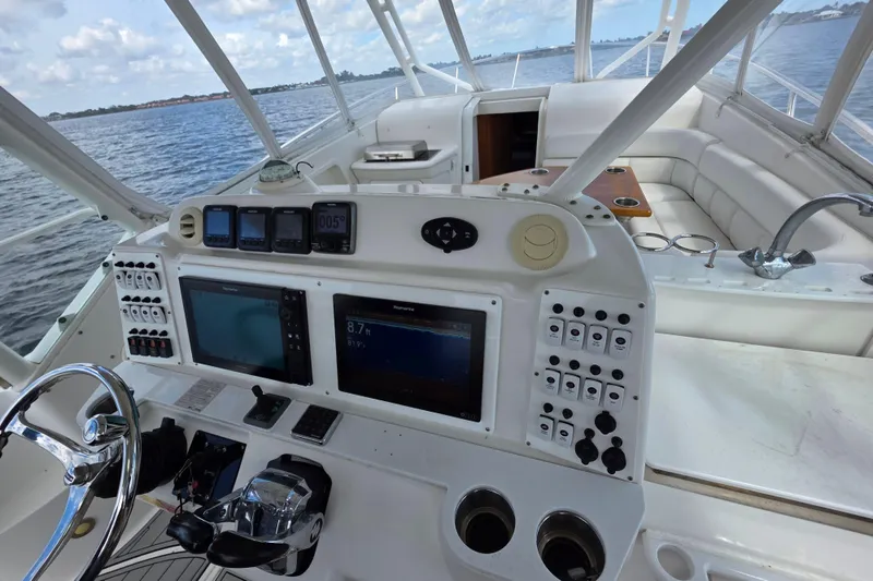 Paradise Bound Yacht Photos Pics Cockpit of 2008 Everglades 350LX boat with navigation controls and seating area.