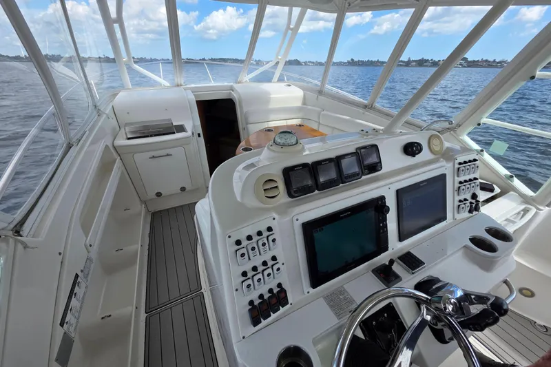 Paradise Bound Yacht Photos Pics 2008 Everglades 350LX boat cockpit with navigation controls, steering wheel, and ocean view.