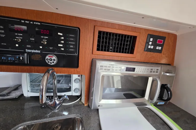 Paradise Bound Yacht Photos Pics 2008 Everglades 350LX boat kitchen with control panel, microwave, and sink.