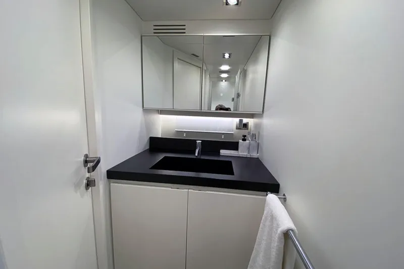  Yacht Photos Pics Modern bathroom in 2013 Wally 55 yacht with sleek black countertop and mirrored cabinet.