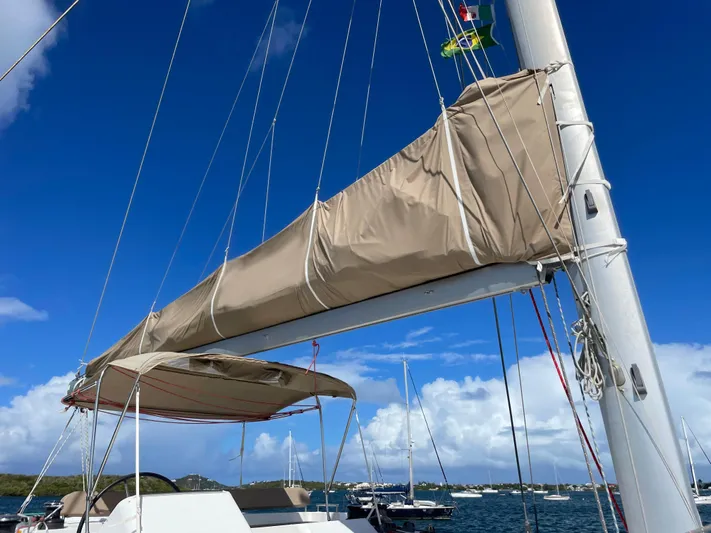 Pasha Yacht Photos Pics 2012 Lagoon 450F sailboat mast and boom against clear blue sky.