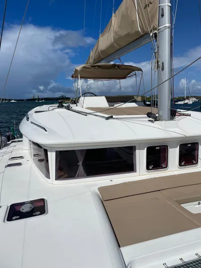 Pasha Yacht Photos Pics 2012 Lagoon 450F catamaran with sails, docked in a sunny marina.