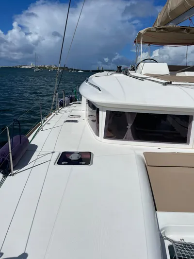 Pasha Yacht Photos Pics 2012 Lagoon 450F catamaran on calm waters under a partly cloudy sky.