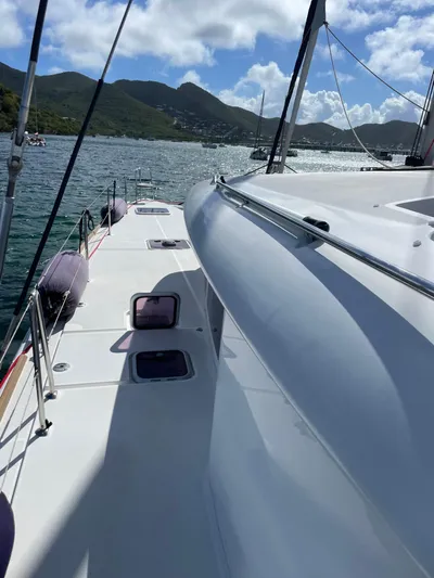 Pasha Yacht Photos Pics 2012 Lagoon 450F catamaran on water, scenic mountain backdrop, sunny day.