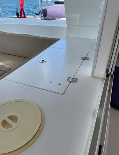Pasha Yacht Photos Pics Interior view of 2012 Lagoon 450F catamaran, featuring sleek white surfaces and seating area.