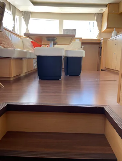 Pasha Yacht Photos Pics Interior of 2012 Lagoon 450F yacht with wooden flooring and modern seating area.