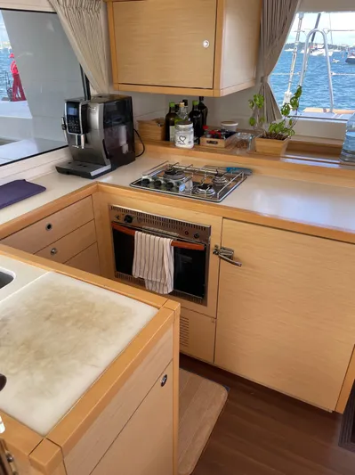 Pasha Yacht Photos Pics Modern kitchen in a 2012 Lagoon 450F yacht with stove, oven, and coffee maker.