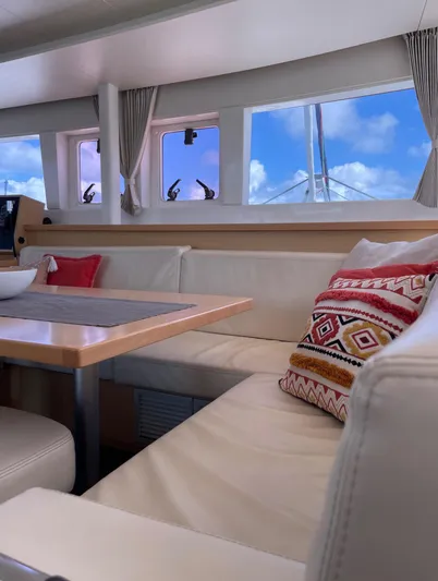 Pasha Yacht Photos Pics Interior of 2012 Lagoon 450F yacht with cozy seating and decorative pillows.