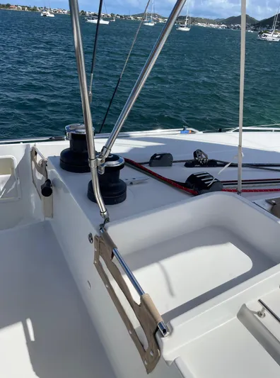 Pasha Yacht Photos Pics 2012 Lagoon 450F yacht deck with winches and ropes, overlooking a scenic harbor.