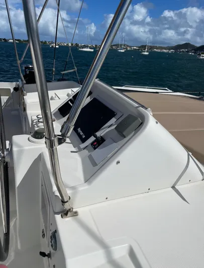 Pasha Yacht Photos Pics Lagoon 450F yacht helm with navigation equipment, overlooking a scenic marina.