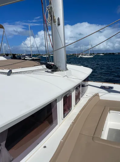 Pasha Yacht Photos Pics 2012 Lagoon 450F catamaran on water, clear sky, and distant sailboats.