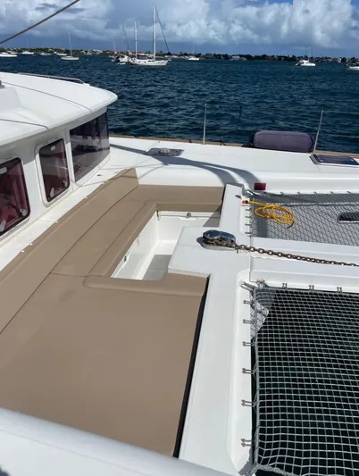 Pasha Yacht Photos Pics Catamaran Lagoon 450F 2012 on water, featuring deck seating and netting.