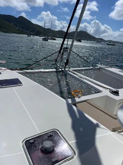 Pasha Yacht Photos Pics Lagoon 450F catamaran deck with ocean view, sunny day, and distant hills.