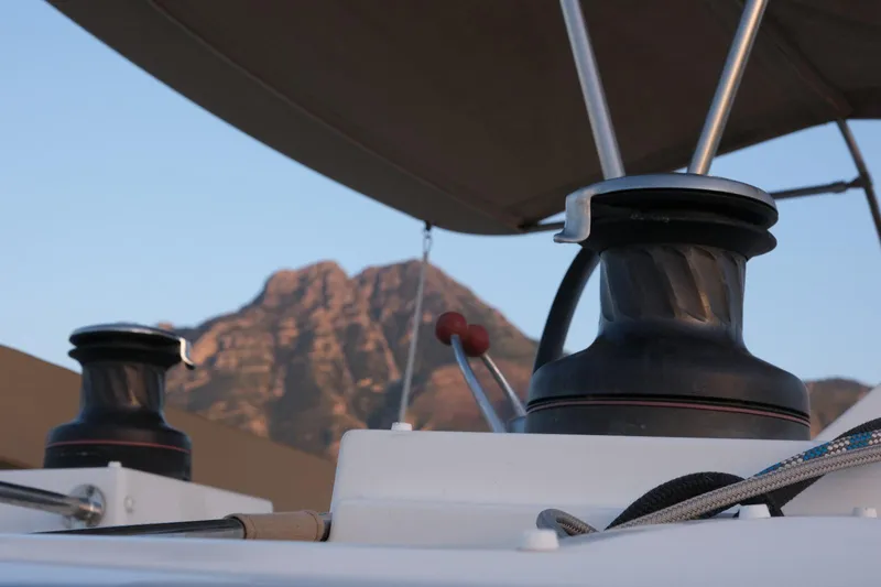 Pasha Yacht Photos Pics Close-up of winches on a 2012 Lagoon 450F catamaran with mountain backdrop.