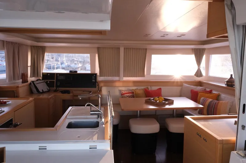 Pasha Yacht Photos Pics Interior of 2012 Lagoon 450F catamaran with modern kitchen and cozy dining area.