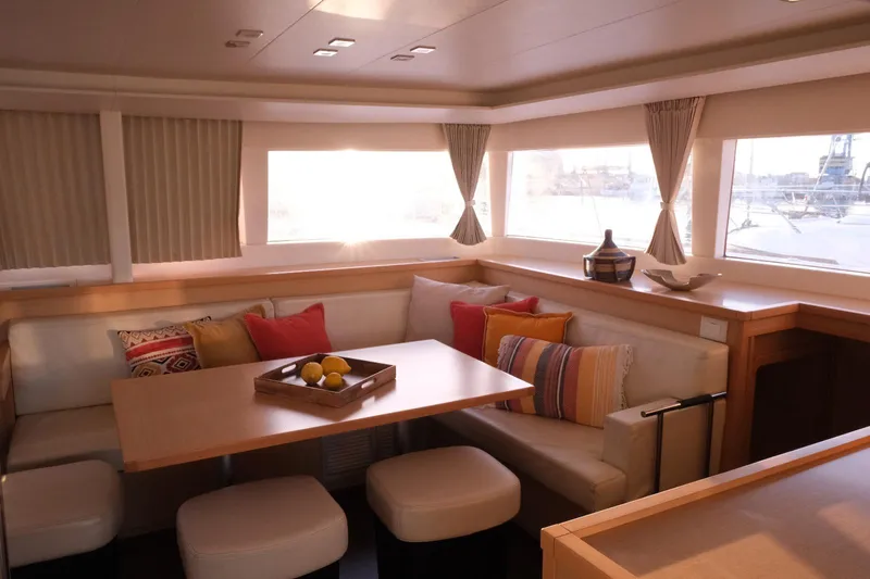 Pasha Yacht Photos Pics Luxurious interior of 2012 Lagoon 450F catamaran with cozy seating and decorative pillows.