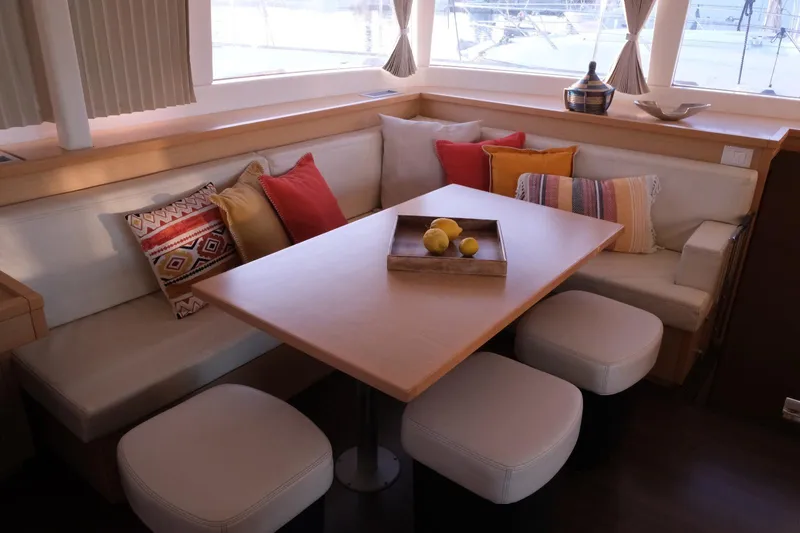 Pasha Yacht Photos Pics Interior of 2012 Lagoon 450F yacht with cozy seating and colorful cushions.