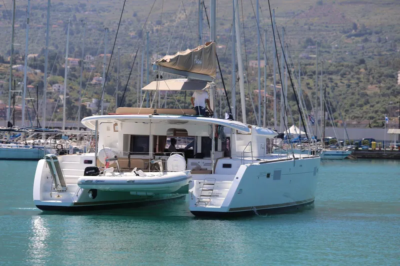 Pasha Yacht Photos Pics 2012 Lagoon 450F catamaran docked in a marina with scenic hillside backdrop.