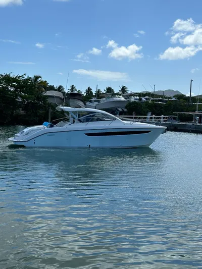  Yacht Photos Pics 2014 Pursuit SC 365i Sport Coupe on calm waters with a clear sky.