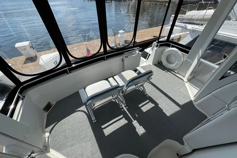  Yacht Photos Pics 2004 Carver 444 Cockpit Motor Yacht interior with chairs, overlooking water.
