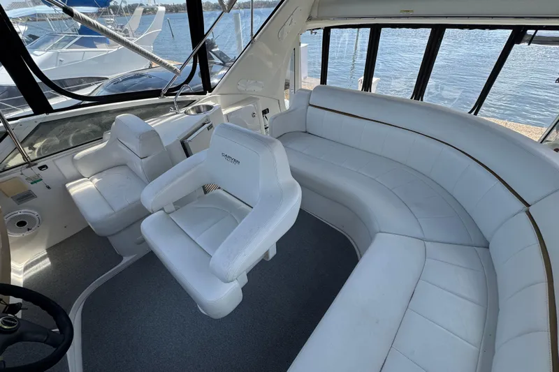  Yacht Photos Pics 2004 Carver 444 Cockpit Motor Yacht interior with white seating and helm, overlooking water.