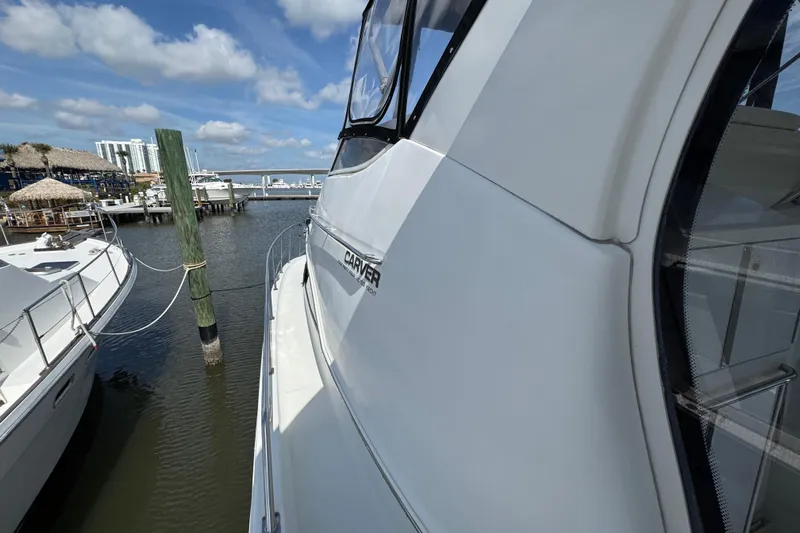  Yacht Photos Pics 2004 Carver 444 Cockpit Motor Yacht docked at marina under blue sky.