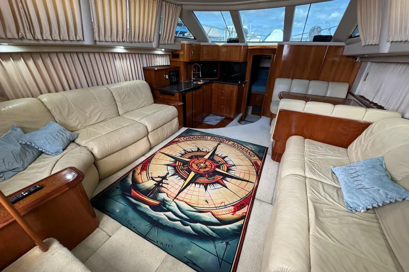  Yacht Photos Pics Luxurious interior of 2004 Carver 444 Cockpit Motor Yacht with plush seating and nautical-themed decor.