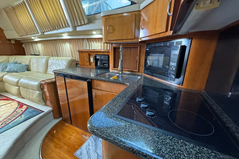  Yacht Photos Pics Luxurious interior of 2004 Carver 444 Cockpit Motor Yacht with modern kitchen amenities.