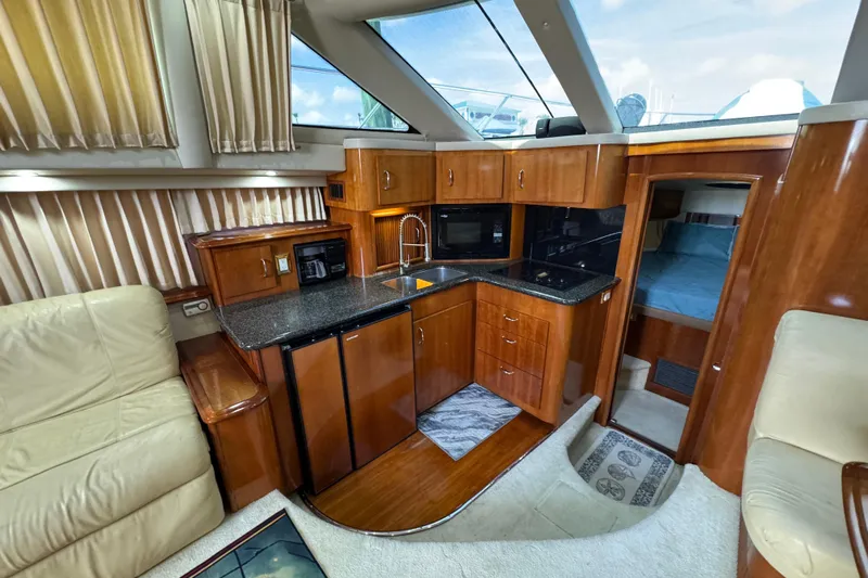  Yacht Photos Pics Luxurious interior of 2004 Carver 444 Cockpit Motor Yacht with modern kitchen and cozy seating.