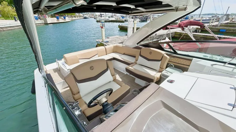  Yacht Photos Pics 2014 Cruisers Sport Series 328 Bow Rider at marina, featuring luxurious seating and helm.