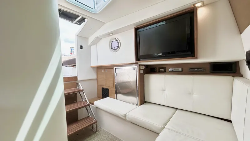  Yacht Photos Pics Interior of 2014 Cruisers Sport Series 328 Bow Rider with TV and seating area.