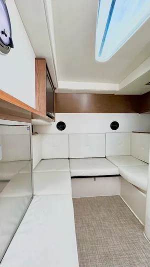  Yacht Photos Pics 2014 Cruisers Sport Series 328 Bow Rider interior with white seating and skylight.