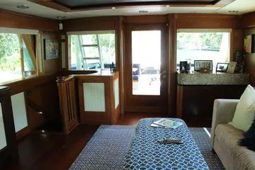  Yacht Photos Pics Interior of 1983 Cheoy Lee 90 cockpit motor yacht, featuring elegant wood finishes and cozy seating.