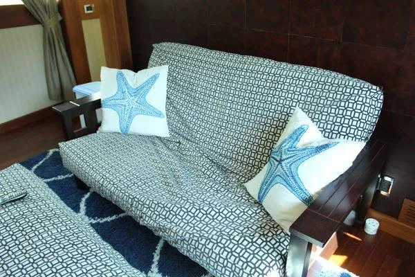  Yacht Photos Pics Cozy yacht interior with patterned sofa and starfish-themed pillows, Cheoy Lee 90 cockpit motor yacht.