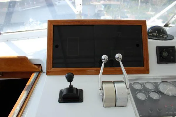  Yacht Photos Pics Control panel of 1983 Cheoy Lee 90 cockpit motor yacht with throttle levers and gauges.