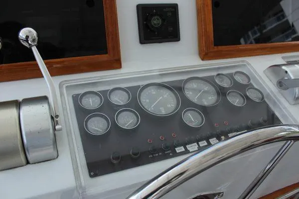  Yacht Photos Pics Control panel of 1983 Cheoy Lee 90 cockpit motor yacht with gauges and steering wheel.