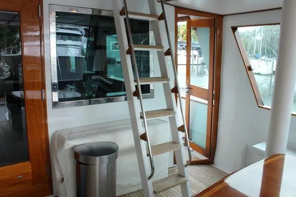  Yacht Photos Pics Interior of 1983 Cheoy Lee 90 cockpit motor yacht with ladder and wooden accents.