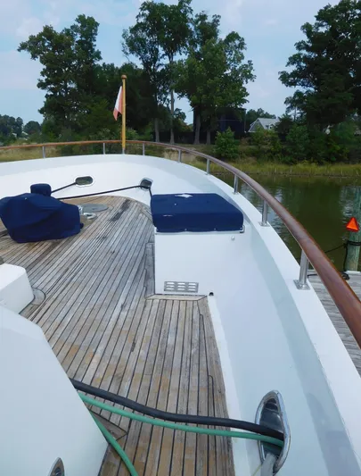 Yacht Photos Pics 1983 Cheoy Lee 90 cockpit motor yacht deck with wooden flooring and covered seating.