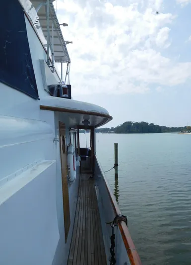  Yacht Photos Pics 1983 Cheoy Lee 90 cockpit motor yacht on calm waters, side view.