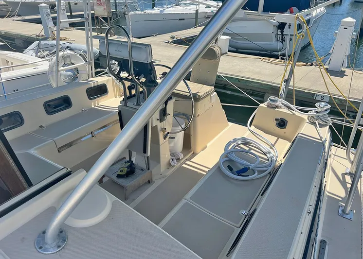  Yacht Photos Pics 1998 Island Packet Cat 35 sailboat cockpit with marina background.