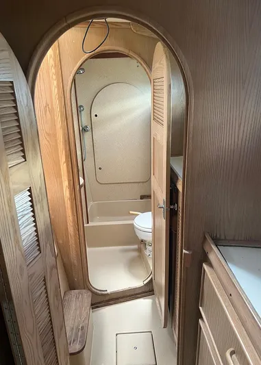  Yacht Photos Pics 1998 Island Packet Cat 35 yacht interior, featuring a compact bathroom with wooden accents.