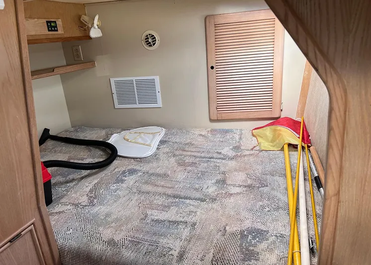  Yacht Photos Pics Interior cabin of 1998 Island Packet Cat 35 sailboat with storage and cleaning tools.