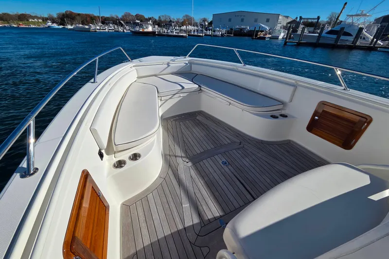  Yacht Photos Pics 2013 Boston Whaler 320 Outrage boat interior with seating and wooden deck.