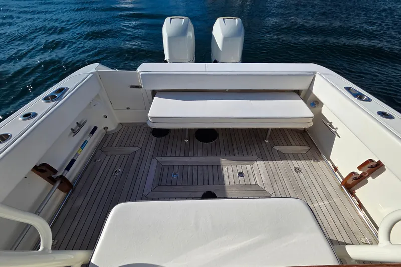  Yacht Photos Pics 2013 Boston Whaler 320 Outrage boat interior with seating and twin engines on water.