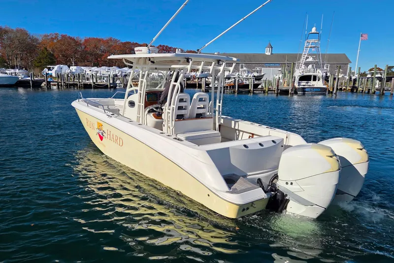  Yacht Photos Pics 2013 Boston Whaler 320 Outrage boat docked in a marina with twin engines.