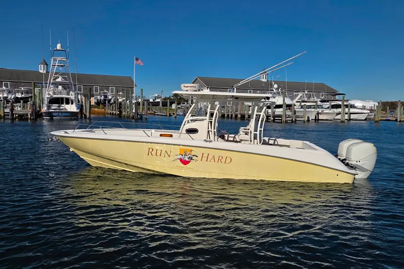  Yacht Photos Pics 2013 Boston Whaler 320 Outrage boat docked at marina under clear blue sky.