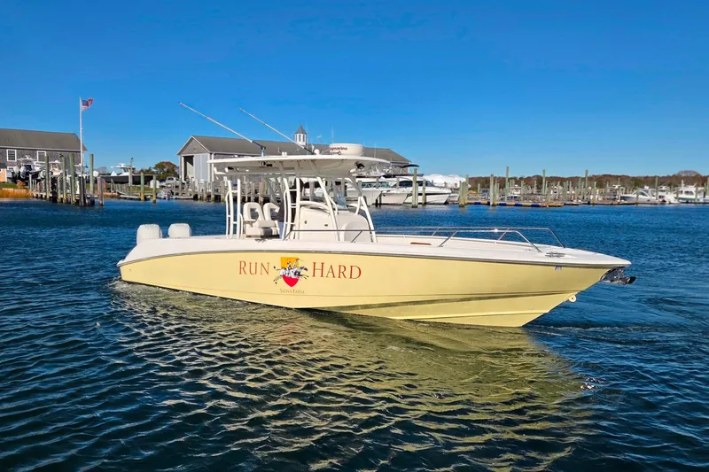  Yacht Photos Pics 2013 Boston Whaler 320 Outrage boat on water, sunny day, marina background.