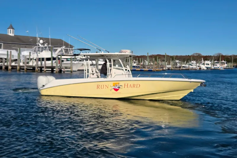  Yacht Photos Pics 2013 Boston Whaler 320 Outrage boat on water near marina, clear blue sky.