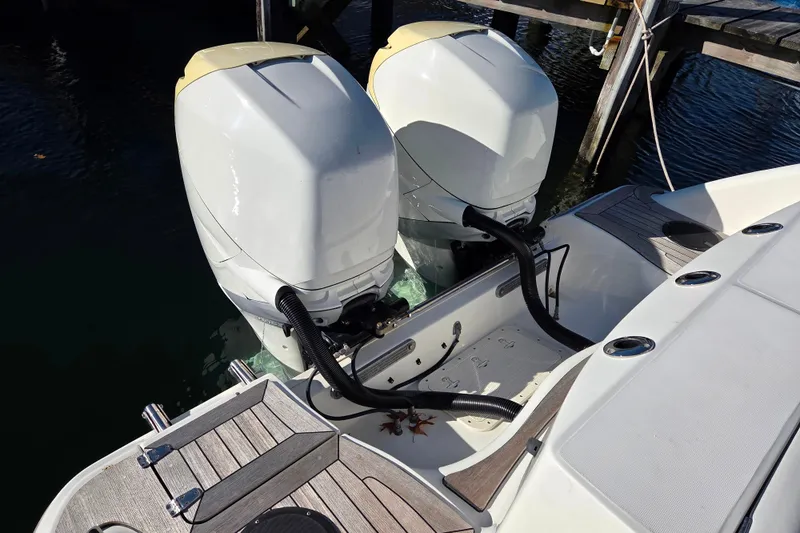  Yacht Photos Pics Twin outboard engines on a 2013 Boston Whaler 320 Outrage boat docked by the water.