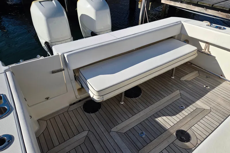  Yacht Photos Pics 2013 Boston Whaler 320 Outrage boat interior with cushioned seating and twin outboard engines.